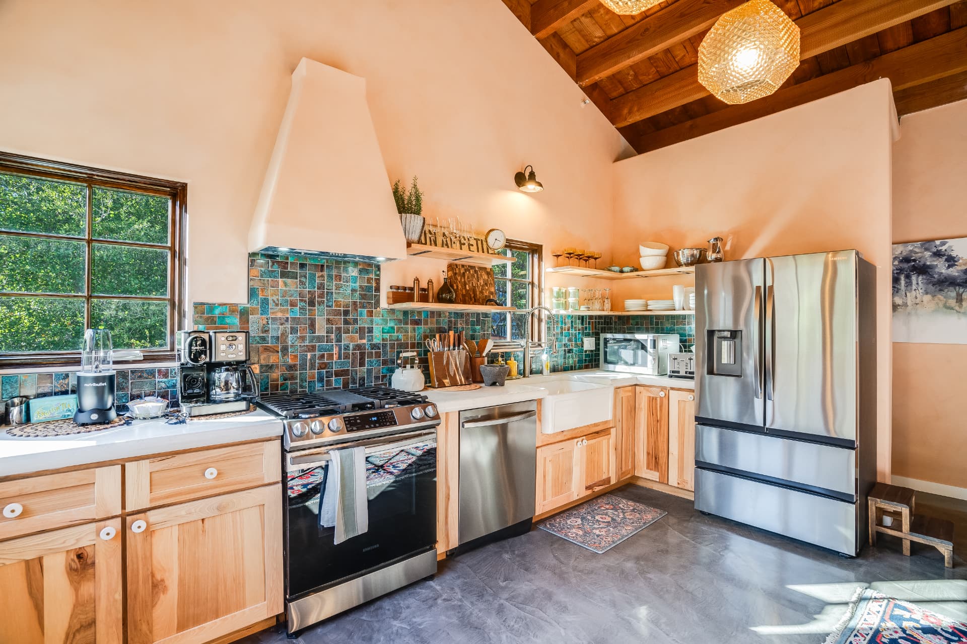 Completed kitchen remodel with natural hickory cabinetry, quartz counters, and a full tile backsplash in a Los Angeles home